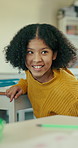 Talking, education and child in classroom at school for question, conversation or learning. Happy, girl and student with smile at desk at academy for development, growth or communication at campus.