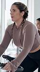 Spin class, training and woman with bike, fitness and exercise for body strength, wellness or active. Gym, endurance and people on machine for workout routine, cardio and cycling for health goals