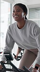Spin class, energy and woman with bike, fitness and training for body strength, wellness and active. Gym, endurance and people on machine for workout routine, cardio and cycling for health goals