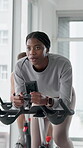 Spin class, exercise and woman with bike, cardio and training for body strength, wellness or active. Gym, endurance and people on machine for workout routine, healthy and cycling for fitness goals
