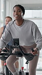 Spin class, cycling and woman with bike, cardio and training for body strength, wellness and active. Gym, endurance and people on machine for workout routine, mobility and exercise for fitness goals