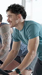 Fitness, happy man and cycling in spin class with bike for cardio workout, training and wellness. Person, group and energy in gym with equipment for endurance challenge, speed exercise and mobility.