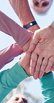 Senior people, hands and stack for motivation, solidarity or fitness support in outdoor park. Collaboration, happy group and friends together for teamwork goals, mission or workout exercise below