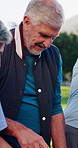 Senior man, volunteer and team talk at park for aid distribution, help and support with accountability. Person, ngo leader and group with discussion, woman or event management for charity drive