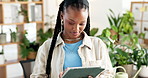 Happy, volunteer and black woman in workspace, tablet and typing with environmental responsibility. African person, tech and activist with digital app, eco friendly and social media for NGO project