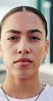 Face, serious and athlete woman in city for fitness, cardio exercise and marathon practice. Portrait, female person and confident for sports training, endurance challenge and morning routine outdoor