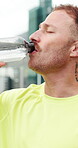 Fitness, man and drinking water in city with bottle for sports hydration, workout and exercise break. Active, person outdoor and wellness with beverage for thirst, liquid electrolytes and recovery.