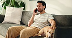 Phone call, talking and man with dog on sofa in home for communication, contact and networking. Bonding, happy and person with pet on smartphone for connection, online chat and relax in living room