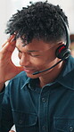 Headache, pain and man in office with headset, frustration or overwhelmed in call center. Telecom, tech or consultant in agency with migraine, burnout or communication issue in customer service.