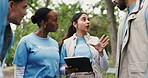 Volunteer, talking and people in park, tablet and community service with social responsibility. NGO business, men and women with tech, app or communication with charity event, planning and leadership