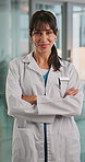 Face, doctor and woman in hospital, arms crossed or smile with confidence, career ambition or pride. Happy person, medical service or professional in clinic, healthcare facility or mission in Denmark