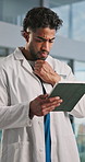 Doctor, man and thinking in hospital with tablet for patient info, medical research and test results. Healthcare worker, person reading or scroll with tech for problem solving, diagnosis and insight.