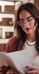 Ecommerce, documents and reading with woman in warehouse for invoice, order information and shipping. Inventory records, supply chain and delivery bills with person in factory for small business