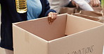 Hands, person and packing box for donation of community service with humanitarian support. Volunteer, cardboard or food drive with essential supplies, charity outreach and aid distribution of poverty