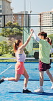 Game, high five and padel with people on court together for competition, scoring or training. Celebration, fitness and point with sports team playing tennis outdoor for challenge or tournament
