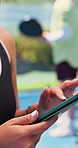 Hands, phone and woman on tennis court with contact, break and schedule or web chat at exercise club. Person, athlete and smartphone with scroll for training, fitness and mobile app for social media