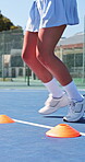 Fitness cones, feet and woman with agility practice on tennis court for balance, coordination or health. Athlete, running and footwork drills outdoor for sports endurance, match speed or game control