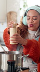 Home, cooking or happy woman with headphones, dancing or salt container with recipe. Sound, ingredients or person in kitchen, healthy meal or audio with snack, smile or streaming music with nutrition