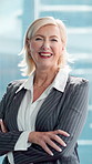 Mature woman, face and arms crossed at office with pride, happy or actuary career at insurance company. Person, smile and consultant in portrait, job or confident at risk management agency in Germany