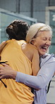 Celebration, hug and women at padel court for match, training or cardio workout together. Happy, athletes and mature female friends embracing for sports game, practice or exercise for wellness.