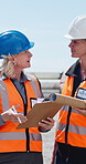 Talk, women and construction site inspection with clipboard, outdoor or architecture with blueprints. Laughing, civil engineers and people with document for property development and quality assurance