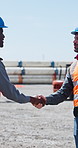 Handshake, industry and construction team on site for partnership, agreement or collaboration. Teamwork, shaking hands and contractor with civil engineer with deal, welcome or greeting at meeting.