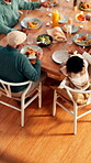 Food, thanksgiving and above of family in dining room for nutrition, bonding and festive gathering. Health, holiday season and lunch with people eating in home for reunion, relax and meal together