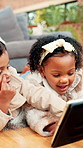 Happy children, floor and playing with tablet in home for entertainment or games together. Girl, boy or playful siblings with technology for online interaction, learning or streaming app in house