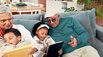 Home, grandparents and kids with book, tablet and bonding together with help, relax and online games. Family, man and woman on couch, reading and learning with digital app, playful and internet