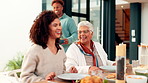 Family, food and women with conversation, smile and bonding together with social gathering. Mother, adult daughter and discussion with lunch, event and Thanksgiving celebration with love and home