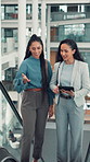 Conversation, escalator and tablet with business woman in airport together for planning or travel. App, commute and international trip with employee people speaking in terminal for work strategy