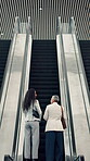 Back, conversation and escalator with business woman in airport together for planning or travel. Ascend, commute and international trip with employee people speaking in terminal for work strategy