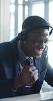Happy, black man and consultant with headset for winning, celebration or promotion bonus in office. Excited, businessman or agent with smile, laptop or victory for good news or success in workplace