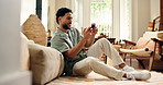 Laughing, gamer and man with smartphone in lounge, fun and gaming with subscription on web in house. Playing, esports and person with tech for entertainment, online or digital competition with mobile