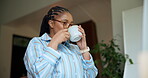 Drinking, coffee and woman in home, calm and start day with warm beverage in apartment and thinking. Morning, mindfulness and black person with tea for health benefits, liquid and caffeine boost