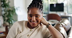 Happy, sofa and face of African woman in home to relax, rest and free time on weekend. Apartment, living room and portrait of person with smile, laugh and chill on couch for calm, wellness and peace