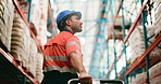 Distribution, back and man in warehouse, trolley and restock inventory with supply chain. Person, pallet truck and employee in factory, engineer and moving freight with logistics or shipping industry