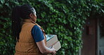 Walking, courier and box with black woman outdoor for shipping, distribution service or ecommerce parcel. Online shopping package, delivery and cargo with person and tablet for supply chain checklist