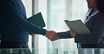 Business people, handshake and meeting in office with finance report, budget review or statement. Accountant, welcome and shaking hands with tech for financial audit or company performance evaluation