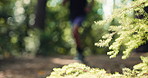 Fitness, man and running in forest with legs for marathon preparation, exercise challenge or wellness. Bokeh, blur and person outdoor in nature with cardio workout, endurance and trail race training.