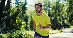 Athlete, man and run for fitness in forest with exercise, cardio training and morning routine. Bokeh, male runner and check smart watch for endurance workout, fresh air and improve stamina in nature