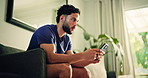 Thinking, man and online with smartphone on couch, browsing or communication with contact on website. Typing, message and person with mobile in house, reflection and texting on social media app