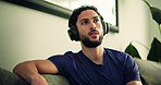 Calm, headphones and man on sofa in home listening to music for relax, peace or mindfulness. Thinking, audio tech and male person chilling in living room with album, radio or playlist at apartment.