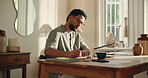 Man, laptop and typing for remote work from home, coffee or glasses with smile for project management. Person, freelance writer and computer for review, happy or editing process for article at house