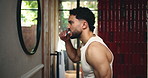 Bathroom, man and brushing teeth by mirror for dental wellness, oral hygiene or gum health. Home, person and cleaning with toothbrush for fresh breath, orthodontics and self care with morning routine