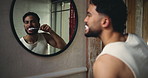 Bathroom, man or brushing teeth by mirror for wellness, oral hygiene or gum health. Home, person or cleaning with toothbrush with reflection for fresh breath, dental or self care with morning routine