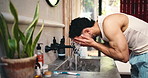 House, washing face and man in bathroom, hygiene and water splash with morning routine. Apartment, faucet and person with liquid, aqua and cleaning with healthy skin, skincare and facial grooming