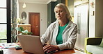Laptop, remote work and typing with woman in home for planning, research or review of information. Computer, feedback and report with freelance employee at counter in apartment for small business