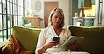 Woman, phone and tablet on sofa, scroll and relax with data sync, backup and download file in home. Person, smartphone and tech on application, share or social media on couch in lounge at house