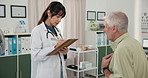 Clipboard, hospital and doctor with senior man for checkup, advice and discussion for results. Healthcare, writing and mature patient and woman for wellness, medical service or appointment in clinic